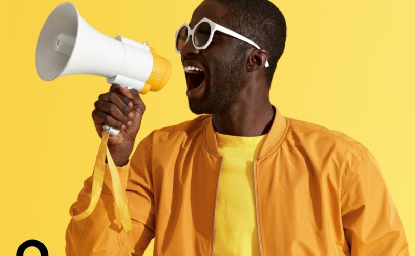 man in a yellow jacket with a megaphone